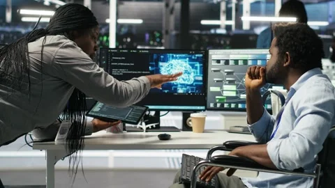 Admin in wheelchair and data center coworker work together using node tree tool Stock Footage 309115588