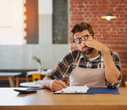 This admin will be the end of me. Shot of an exhausted young business owner d Stock Photos