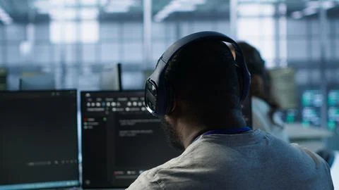 Admin working in computer network security data center listening music Stock Photos