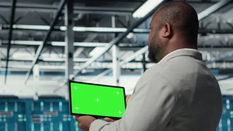 Admin working in server farm using isolated screen tablet to analyze data Stock Footage 311897133