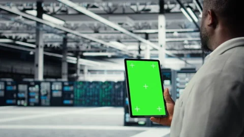 Admin working in server farm using isolated screen tablet to analyze data Stock Footage 311959235