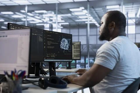 Admin working in server hub, sitting at computer desk Stock Photos