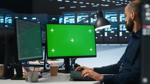 Admin writing code on mockup computer monitor to mend data center racks Stockfoto's