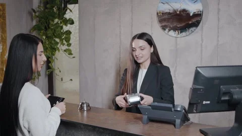 Administrator gives the plastic keys to the room and accepts the payment Video stock 240300980