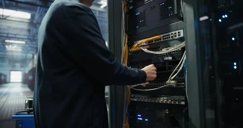 Administrator Inserting Hardware in Server Racks in Data Center Stock Footage 319999266