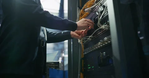 Administrator Inserting Hardware in Server Racks in Data Center Stock Footage 319999290