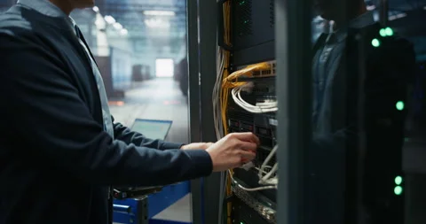 Administrator Inserting Hardware in Server Racks in Data Center Stock Footage 319999342
