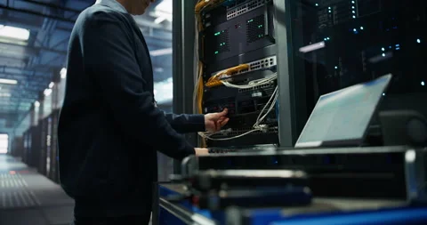 Administrator Inserting Hardware in Server Racks in Data Center Stock Footage 319999582
