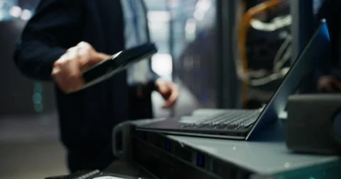 Administrator Inserting Hardware in Server Racks in Data Center Stock Footage 319999624