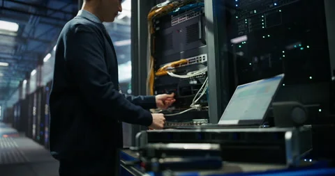 Administrator Inserting Hardware in Server Racks in Data Center Stock Footage 319999789