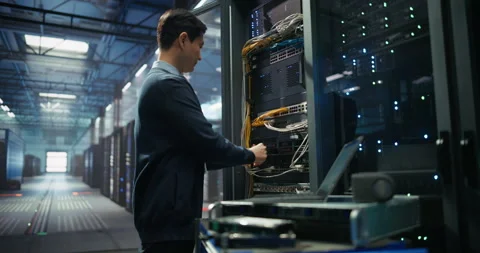 Administrator Inserting Hardware in Server Racks in Data Center Stock Footage 319999810