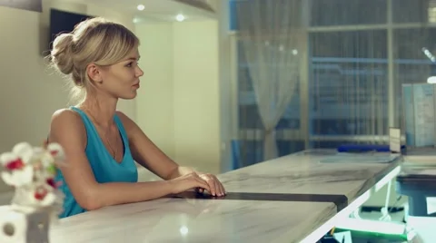 Administrator of spa complex tells the customer about the various services Stock Footage 60142600