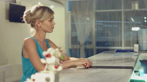 Administrator of spa complex tells the customer about the various services Stock Footage 60142613