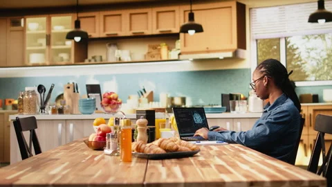 Administrator working remotely with AI tools and laptop for data and metrics Stockbeeldmateriaal 344242730