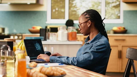 Administrator working remotely with AI tools and laptop for data and metrics Stockbeeldmateriaal 344246508