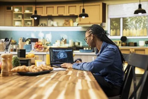 Administrator working remotely with AI tools and laptop for data and metrics Stock Photos