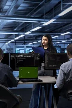 Admins checking supercomputers with mockup notebook device 写真素材