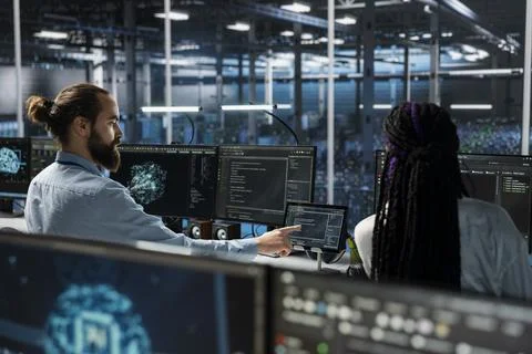 Admins in high tech data center installing server systems helped by AI Stockfoto's