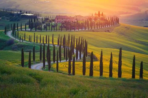 Admirable buildings in the grain fields at sunset, Tuscany, Italy Stock Photos