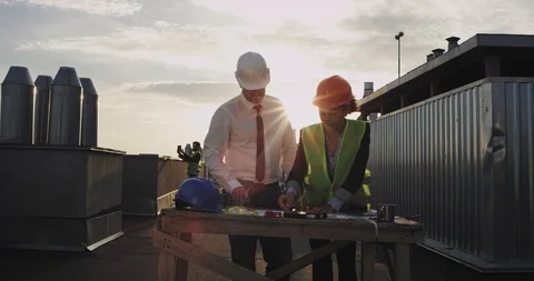 The admirable chubby architect man works with the charming young woman on the Stock Footage 116409098