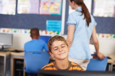 Admiring his work on the computer. A young schoolboy in computer class. 스톡 사진