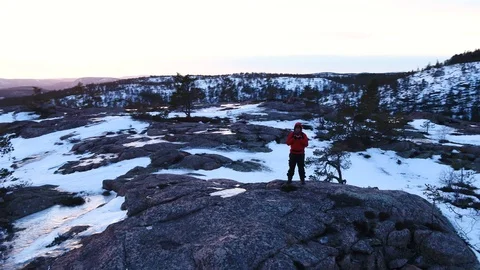 Admiring the view from the top of a rock Видео 105850045