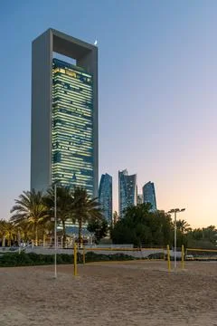 ADNOC headquarters tower at dusk with crescent moon in Abu Dhabi, UAE Foto stock