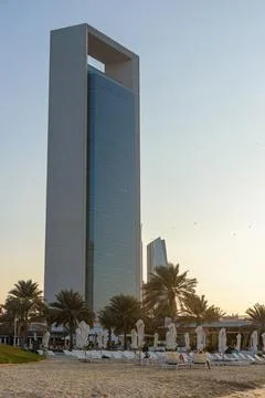 ADNOC Headquarters tower overlooking the beach at sunset in Abu Dhabi Stock Photos