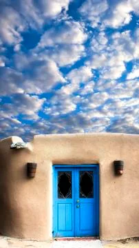 Adobe Building with a Blue Front Door Stock Photos