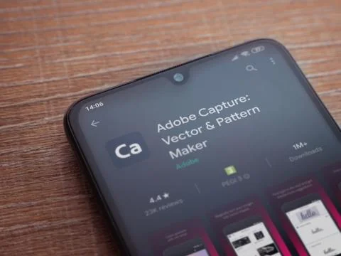 Adobe Capture - Vector and Pattern Maker app play store page on the display o Stock Photos