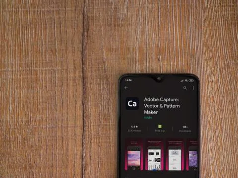 Adobe Capture - Vector and Pattern Maker app play store page on the display o Stock Photos