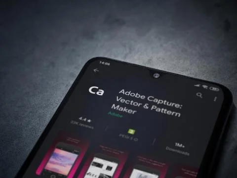 Adobe Capture - Vector and Pattern Maker app play store page on the display o Stock Photos