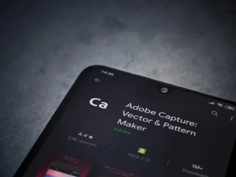 Adobe Capture - Vector and Pattern Maker app play store page on the display o Stock Photos
