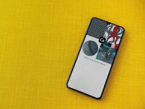 Adobe Capture - Vector and Pattern Maker app play store page on the display o Stock Photos