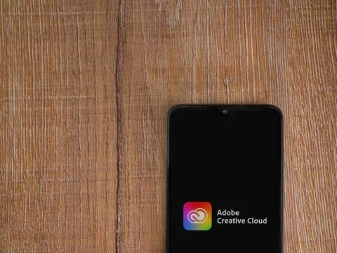 Adobe Creative Cloud app launch screen with logo on the display of a black mo Foto stock