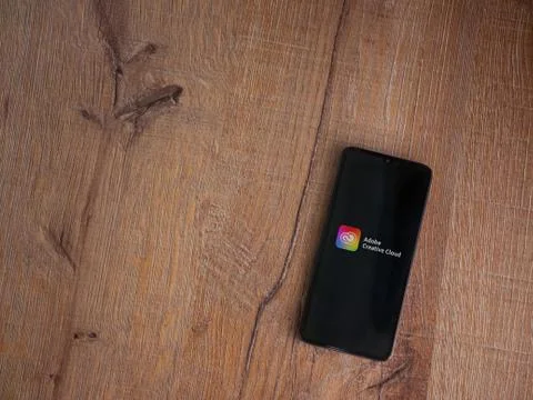 Adobe Creative Cloud app launch screen with logo on the display of a black mo Foto stock