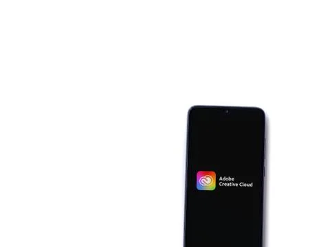 Adobe Creative Cloud app launch screen with logo on the display of a black mo Foto stock