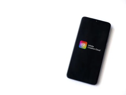 Adobe Creative Cloud app launch screen with logo on the display of a black mo Foto stock