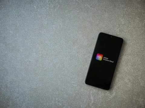 Adobe Creative Cloud app launch screen with logo on the display of a black mo Foto stock