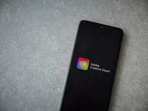 Adobe Creative Cloud app launch screen with logo on the display of a black mo Foto stock