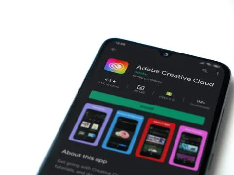 Adobe Creative Cloud app play store page on the display of a black mobile sma Foto stock