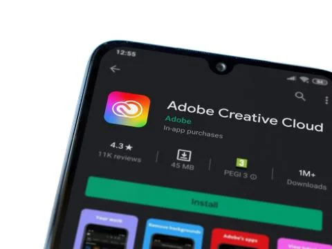 Adobe Creative Cloud app play store page on the display of a black mobile sma Stock Photos