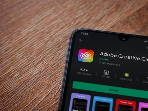 Adobe Creative Cloud app play store page on the display of a black mobile sma Foto stock