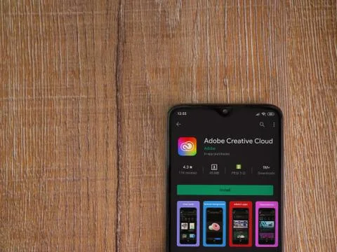 Adobe Creative Cloud app play store page on the display of a black mobile sma Foto stock