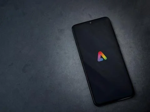 Adobe Express - Graphic Design app launch screen on smartphone on dark marb.. Stock Photos