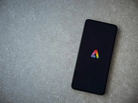 Adobe Express - Graphic Design app launch screen on smartphone on ceramic s.. Stock Photos