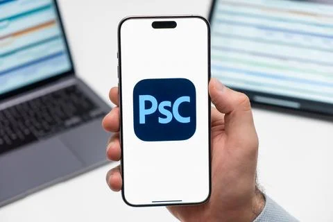 Adobe Photoshop Camera logo on the screen of smartphone in mans hand on the Stock Photos