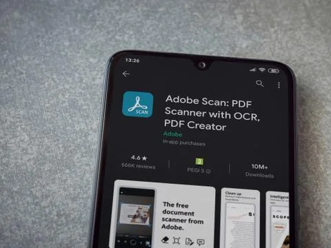 Adobe Scan app play store page on the display of a black mobile smartphone on Stock Photos