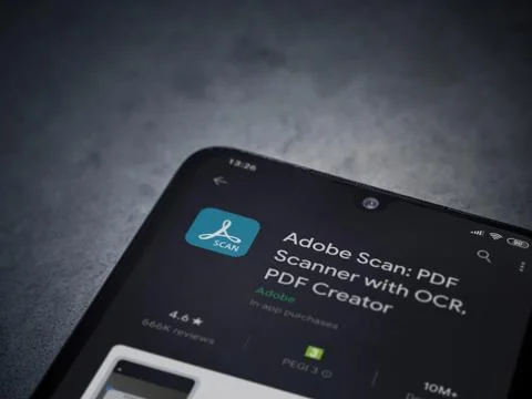 Adobe Scan app play store page on the display of a black mobile smartphone on Stock Photos