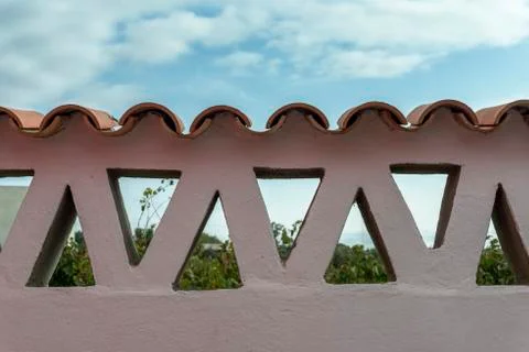 Adobe wall with triangles and tiles Stock Photos